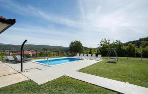 a swimming pool in a yard with chairs around it at Stunning Home In Trilj With Wifi in Trilj