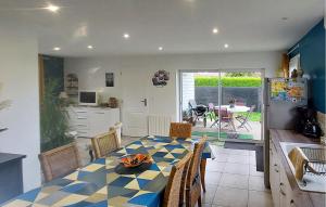 a kitchen and dining room with a table and a table and chairs at Lovely Home In Pretot-Vicquemare in Prétot-Vicquemare