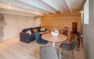 a living room with a couch and a table and chairs at 2 Bedroom Amazing Home In Cusy in Cusy