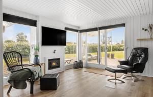a living room with two chairs and a fireplace at 3 Bedroom Lovely Home In Otterup in Otterup