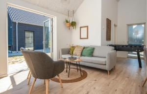 a living room with a couch and a table at Pet Friendly Home In Rømø With Wifi in Kongsmark