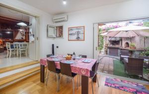 a dining room with a table with chairs and an umbrella at 3 Bedroom Gorgeous Home In Pizzo in Pizzo