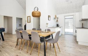 a kitchen and dining room with a table and chairs at Awesome Home In Rømø With Wifi in Kongsmark