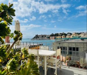 a balcony with a table and chairs and the ocean at Comodissimo Gaslini e mare in Genova