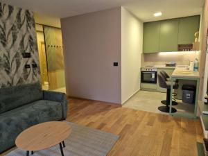 a living room with a couch and a table and a kitchen at Sajam 2 in Novi Sad +16 photos