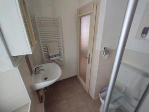 a bathroom with a sink and a toilet and a shower at gemütliches Ferienhaus mit Kamin - Holiday and Nature Wallendorf in Wallendorf