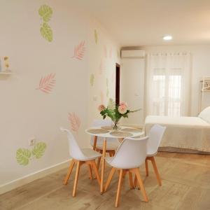 a room with a table and chairs and a bed at APARTAMENTO SOL in Chipiona