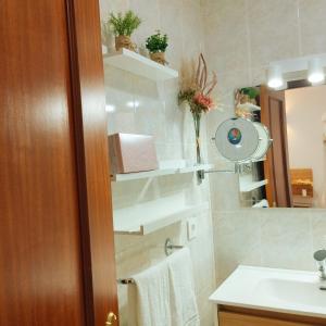 a bathroom with a sink and a mirror at APARTAMENTO SOL in Chipiona +34 photos