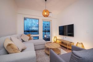 a living room with a couch and a tv at Compact 2BDR Apartment with Private Sauna in Rovaniemi +13 photos