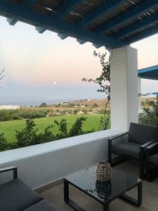 a living room with a view of the ocean at Eliza & Mike's Villas Paros in Kampos Paros