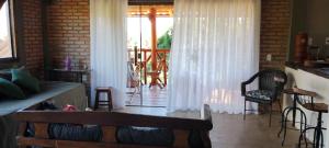 a living room with a couch and a porch at Loft Astanga Serra do Cipó in Serra do Cipo