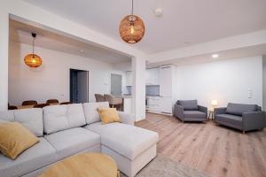 a living room with a white couch and a table at Brand New 2BDR with Private Sauna in Rovaniemi