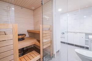 a bathroom with a shower and a toilet and a sink at Brand New 2BDR with Private Sauna in Rovaniemi +24 photos