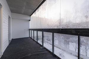 an empty room with a large glass wall at Brand New 2BDR with Private Sauna in Rovaniemi