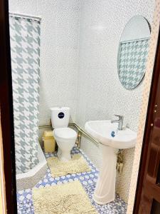ein Badezimmer mit Toilette und Waschbecken in der Unterkunft Turkistan 1 in Türkistan