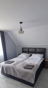 a bedroom with a bed with white sheets and a lamp at # Marysieńka in Busko-Zdrój