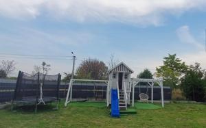 a playground with a white and blue swing set at # Marysieńka in Busko-Zdrój