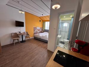 a hotel room with a bed and a table and chairs at Modern Studio 11 private Kitchenette and Bathroom in Limassol