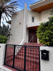 a house with a black fence in front of it at Modern Studio 11 private Kitchenette and Bathroom in Limassol