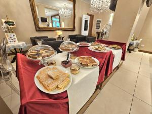 a table with plates of food on top at La Castellana Loft Hotel in Bergamo +97 photos