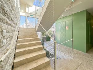 a staircase in a building with a green wall at The J Luxury Apartments Near Mahane Yehuda - Perfect for Shabbat Stays in Jerusalem