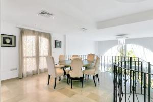 a dining room with a table and chairs at Villa Jacqueline in San Roque in La Alcaidesa