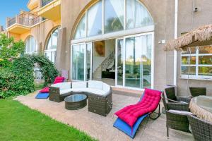 a patio with chairs and a couch and a table at Villa Jacqueline in San Roque in La Alcaidesa