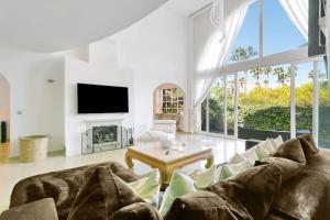 a living room with a couch and a table at Villa Jacqueline in San Roque in La Alcaidesa