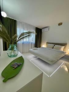 a bedroom with a bed and a green plate on a counter at Luxury apartament40 in Craiova