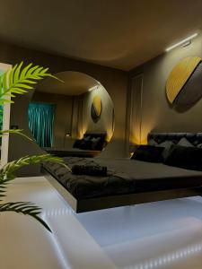 a bedroom with a large bed and a mirror at Luxury apartament40 in Craiova +22 photos