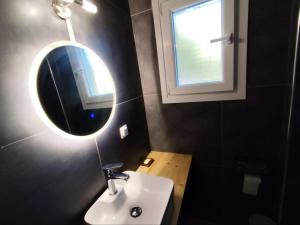 a bathroom with a sink and a mirror on the wall at Pool me up 22 apartment in Megali Ammos +20 photos