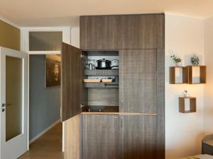 a kitchen with a large wooden cabinet in a room at Schleiblick in Schleswig