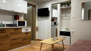 a small kitchen with a small table in a room at Ρομαντικό Πέτρινο Διαμέρισμα για Ζευγάρια - Apt I in Chania Town