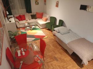 a living room with a couch and a table at Clockwork orange apartment in Vračar (historical)