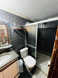 a small bathroom with a toilet and a sink at Apto no centro com 3 quartos in Ilhéus +18 photos