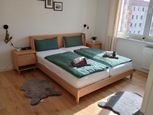 a bedroom with a bed with two stuffed animals on it at Romantic Coswig in Coswig