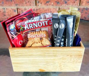 a wooden box filled with different types of snacks at The Major Mitchell Motel in Bourke