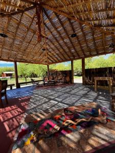 a pavilion with a large rug on a patio at Cabañas el Chañar in San Pedro de Atacama