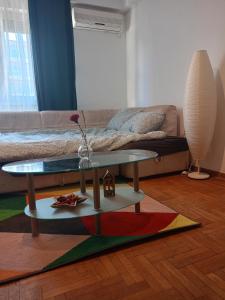 a living room with a table and a couch at Clockwork orange apartment in Vračar (historical)