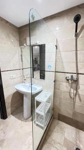 a bathroom with a sink and a glass shower at Studio de luxe in Casablanca