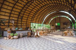 a large building with tables and dogs in it at 2Someplace Resort in Ban Pang Mung