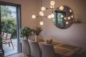a dining room with a table with chairs and a mirror at BK Holiday in Rovinj