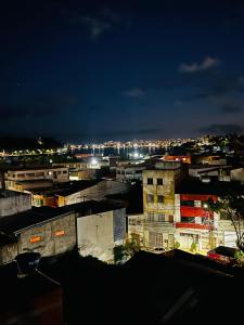 a view of a city at night at Apto no centro com 3 quartos in Ilhéus