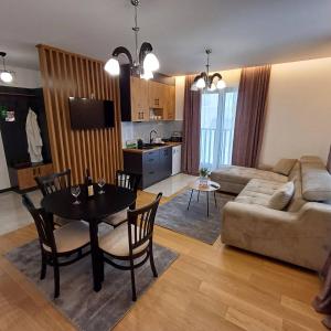 a living room with a table and a couch at Winter House in Kopaonik