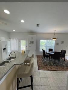 a kitchen and dining room with a table and chairs at Gorgeous condo with pool view in walking distance to Siesta Key Beaches in Sarasota