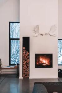 a fireplace in a living room with a fire place at Villa Boreale - Wellness and relaxation in Petite-Rivière-Saint-François