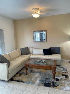 a living room with a couch and a coffee table at Gorgeous condo with pool view in walking distance to Siesta Key Beaches in Sarasota