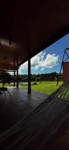 a porch with a view of a grass field at Cabañas del Valle in Huerta Grande