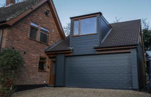 a black garage door with a window on top of a house at Oak View Lodge - Deluxe Master Studio near Ipswich & Woodbridge in Playford