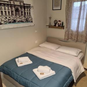 a bedroom with two beds with towels on them at ESTELA House in Ágios Vissaríon +48 photos